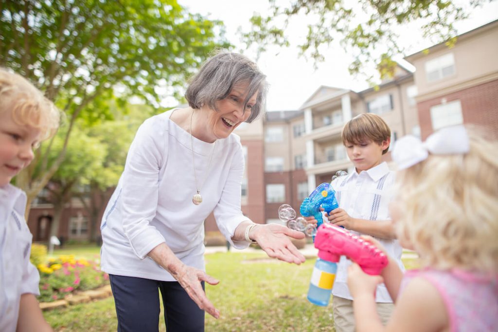 Older Woman Playing with Grandkids Outside