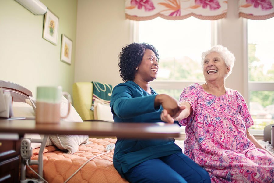 An elderly woman and her caregiver at a Houston, Texas skilled nursing facility