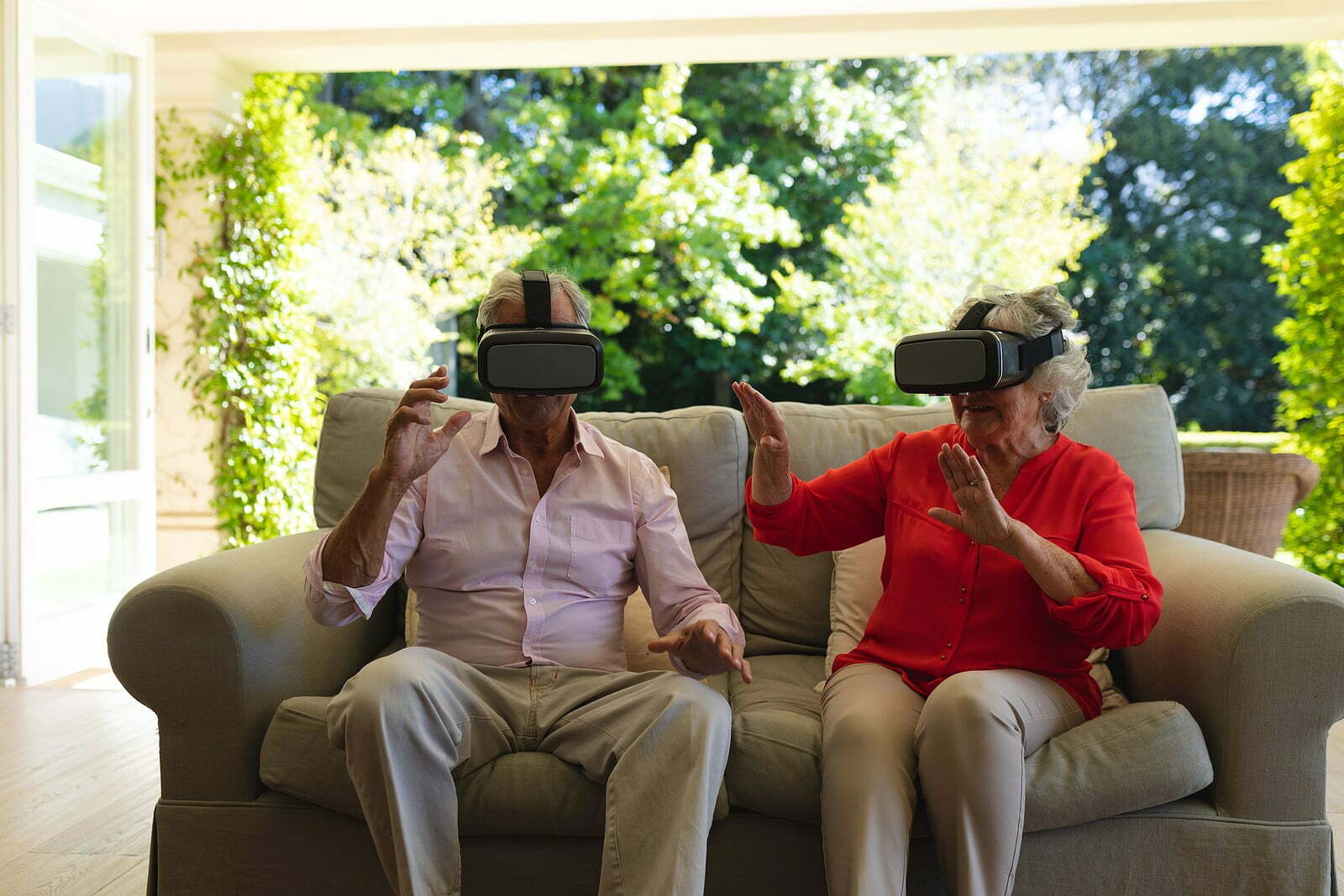 Senior couple using VR headsets together.