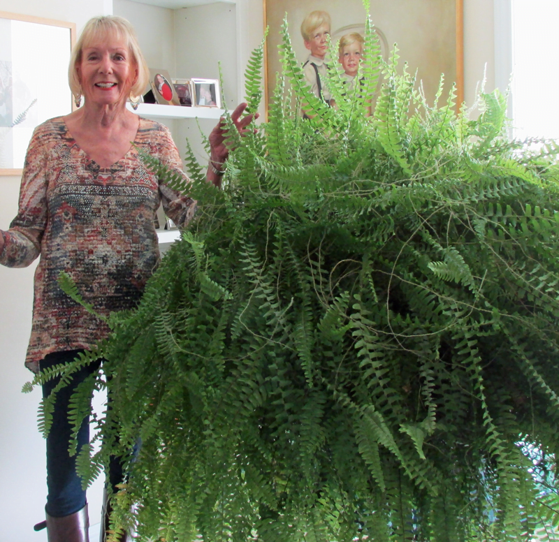 senior woman showing a plant in her senior apartment