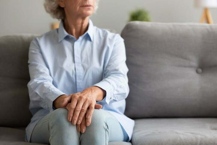 Cropped photo of a senior sitting alone on couch