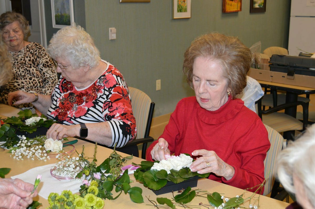 seniors making floral arrangements during a class at the buckingham