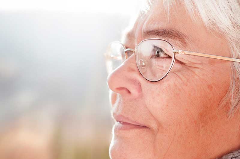 close up photo of a senior woman with glasses