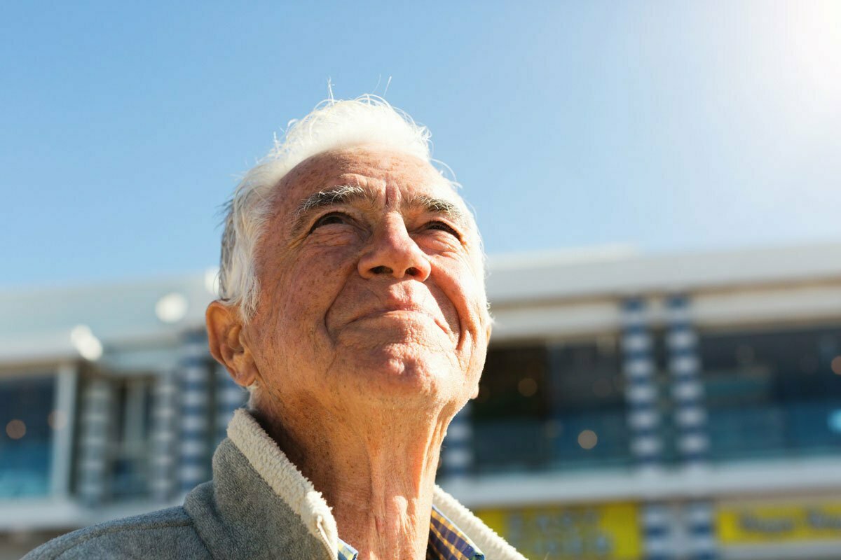 Senior man enjoying the outside and sunshine taking time for spiritual wellness.