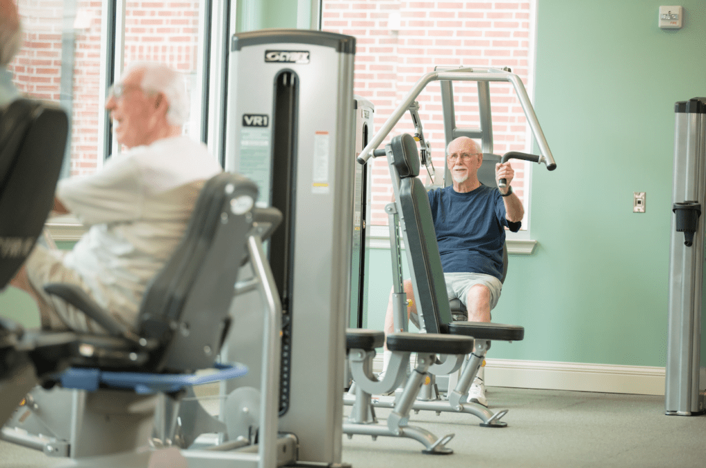 senior man exercising in a fitness center at a retirement community